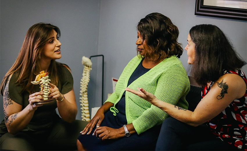 Chiropractor Lawrenceville GA Kathryn Maloof Consulting With Patients