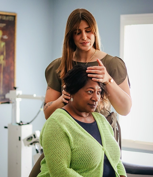 Chiropractor Lawrenceville GA Kathryn Maloof Examining Patient