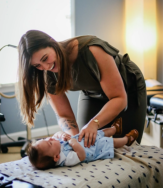 Chiropractor Lawrenceville GA Kathryn Maloof Examining Pediatric Patient